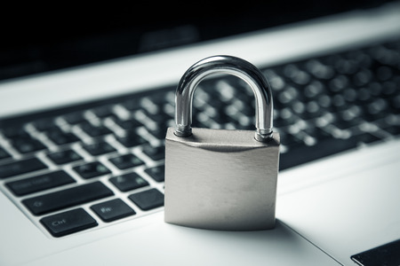 Computer security concept with a closed padlock on the keyboard
