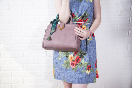 young woman hand beg on brick wall backgroundの写真素材