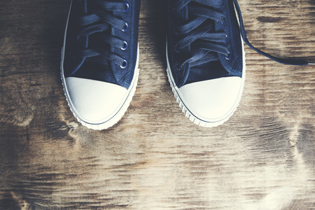 Pair of  sneakers on the wooden tableの写真素材