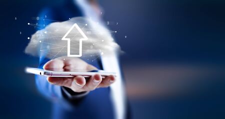 Businessman holding  with upload in the screenの写真素材