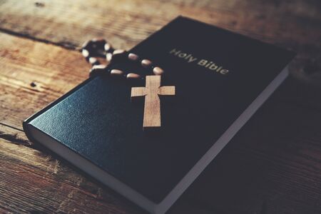cross on holy bible on the wooden tableの写真素材