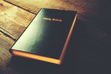holy bible on the brown wooden tableの写真素材