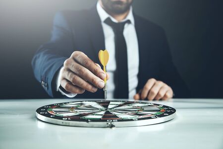 man hand arrow on the board on deskの写真素材