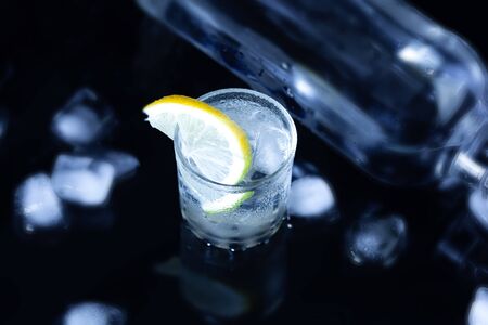 bottle of vodka with limon on the desk