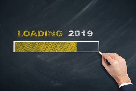 Business Person Drawing Loading 2019 on Blackboardの写真素材
