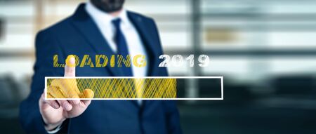 man touching Loading 2019 in screenの写真素材