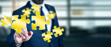 Businessman in his office touching  puzzle