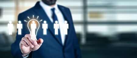 Businessman touching bulb idea with people team in screenの写真素材