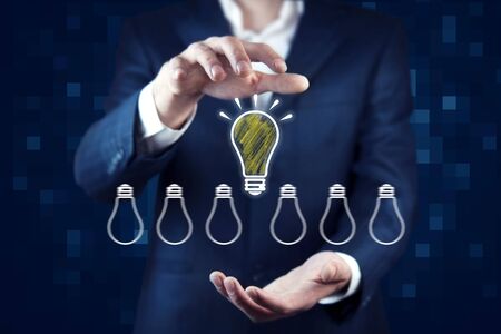 man touching in light bulb in screenの写真素材