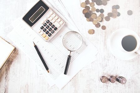 calculator and coins with coffee on documentの写真素材