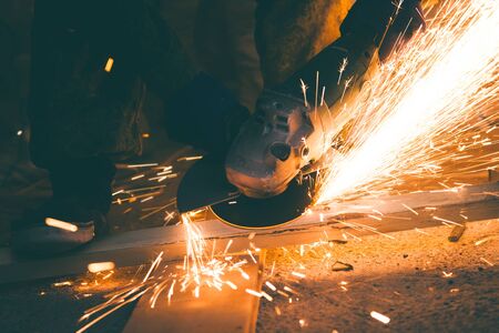 Cutting metal with many sharp sparks in homeの写真素材