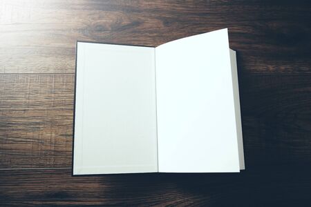 open book on the wooden table background