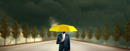 man hand yellow umbrella in rainの写真素材