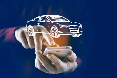 man hand  phone with car model in screenの写真素材