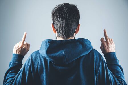 man in the middle finger on gray background