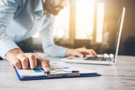 man working in graph with keyboardの写真素材
