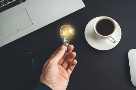 man hand light lulb  in oficeの写真素材