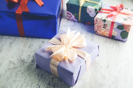 Different color gift boxes on wooden background