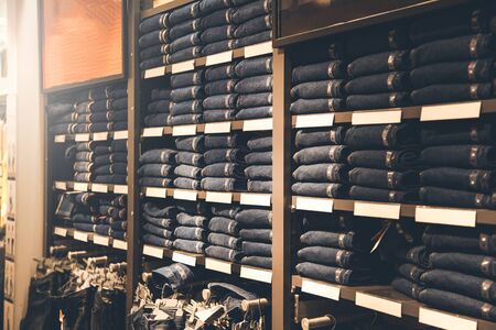 Stack of blue jeans in a shopの写真素材