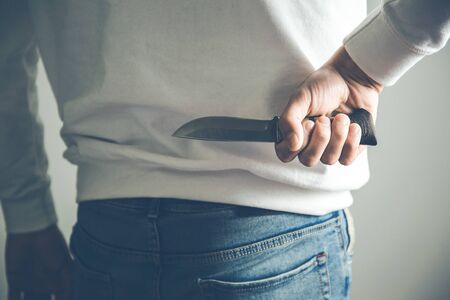 man hand knife in backの写真素材