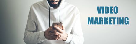 man hand phone with video marketing textの写真素材