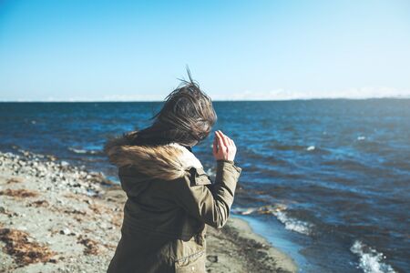 Young girl looking at the lake background