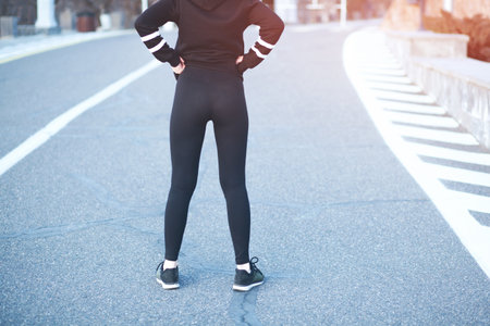 young runner woman in the road backgroundの写真素材