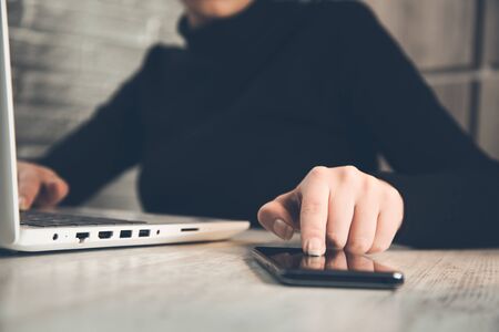 woman hand phone on working desk background