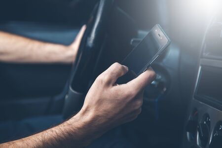 young man hand phone in the car background