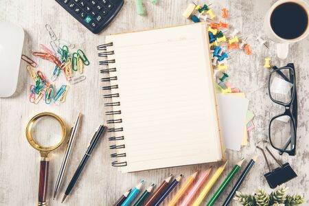 notepad with pencils and coffee on the desk