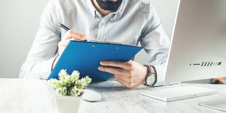 man hand document with  computer keyboard on deskの写真素材