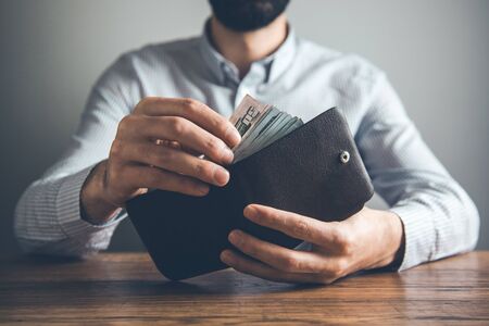 man hand wallet with money  on deskの写真素材