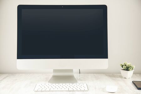 white computer on the wooden desk background