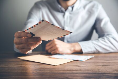 man hand holding letterson the desk backgroundの写真素材