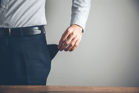 business man hand empty pocket on grey background