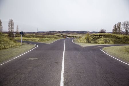highway asphalt road with grass under sky