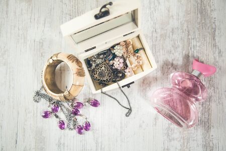 jewelry on the box with perfume on deskの写真素材