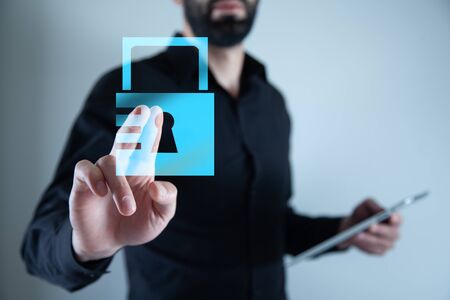 man touching lock in screen hand tabletの写真素材