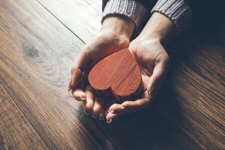 woman hand red  heart on the deskの写真素材