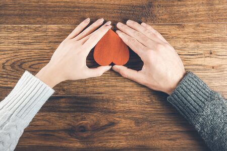 woman and man hand red couple on the deskの写真素材