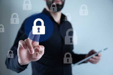 man touching lock in the screen on grey background