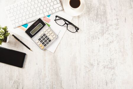 calculator with graph and computer on desktopの写真素材
