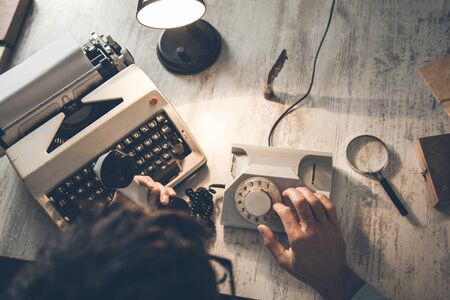man hand phone with typewriter on deskの写真素材