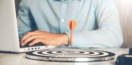 man hand target with computer on the deskの写真素材