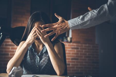 sad woman and angry boss in office background