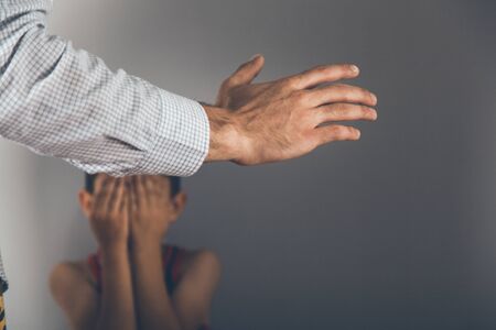 sad baby with angry man on grey backgroundの写真素材