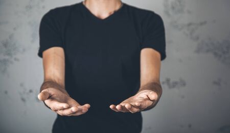 young man empty palm on abstract backgroundの写真素材