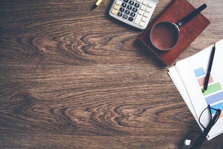 graph with calculator and magnifier on deskの写真素材