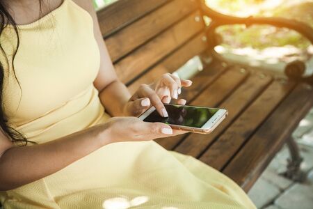 woman hand smart phone sitting on bench