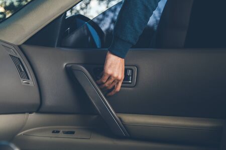man thief hand in car in street